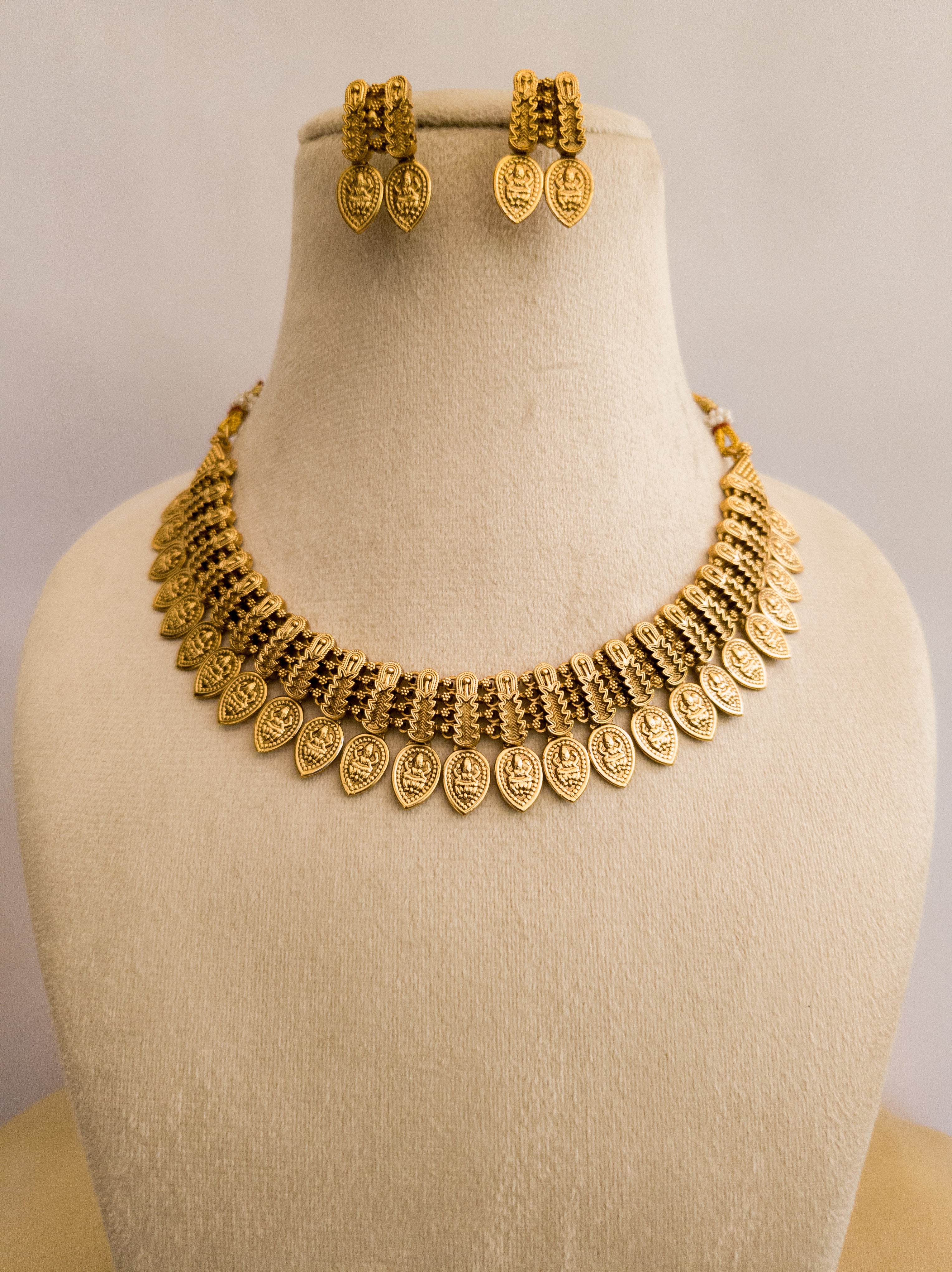 Gold finish traditional necklace with leaf pattern